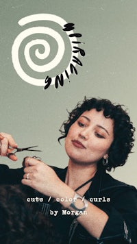 a woman is cutting a woman's hair